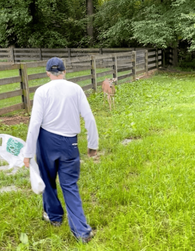 Andrew feeding Deer - Joyous Acres
